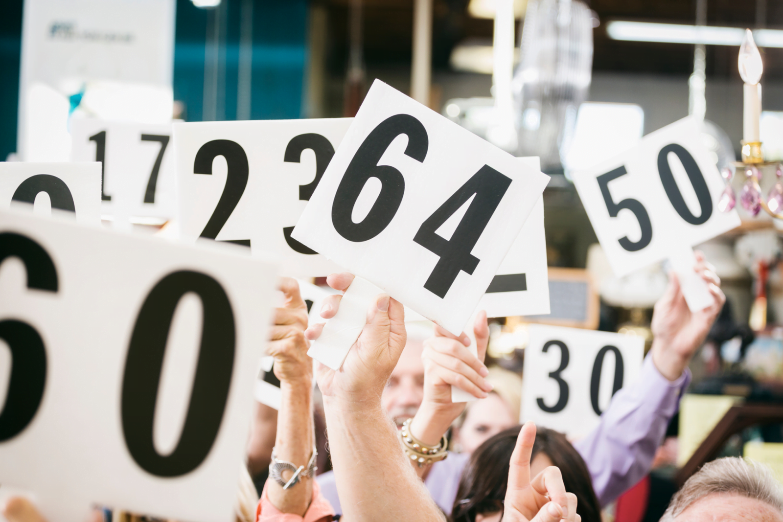 Auction with people holding up numbers