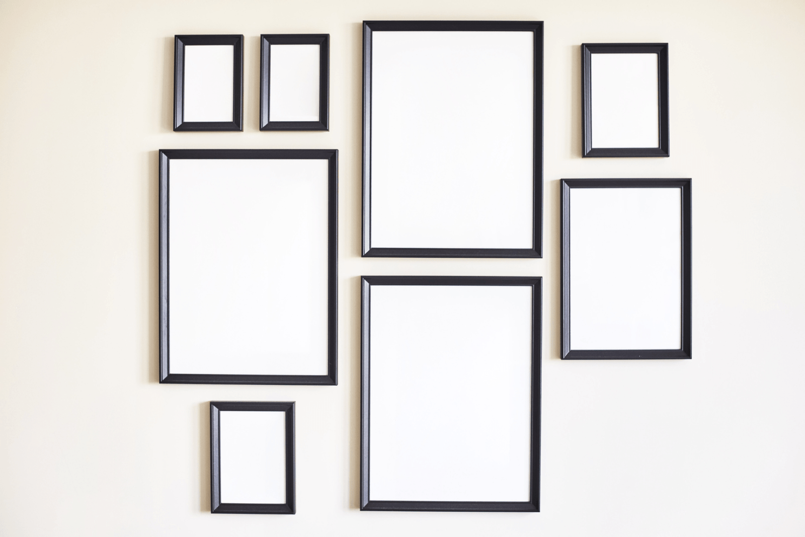 empty frames that are all different sizes on a wall